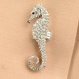 An 18ct gold diamond seahorse brooch, with sapphire eye, by E Wolfe & Co.