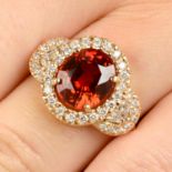 An 18ct gold spessartine garnet and diamond dress ring.