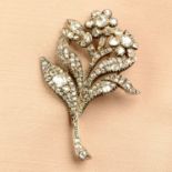 A late 19th century silver and gold old-cut diamond floral brooch.Estimated total diamond weight