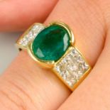 An emerald single-stone ring, with pavé-set diamond shoulders.