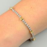 An 18ct gold 'yellow' diamond and diamond line bracelet.