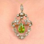 An early 20th century silver and gold, peridot and diamond pendant.May be worn as a brooch.