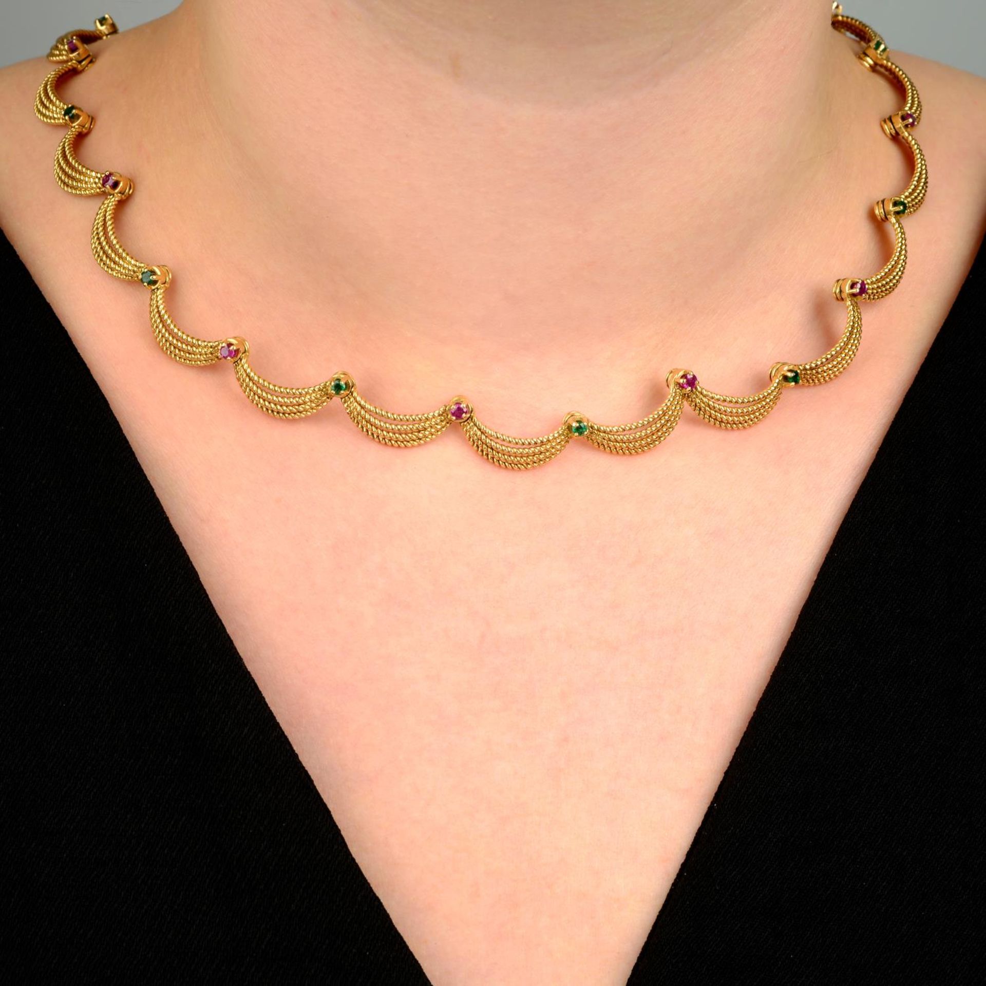 A mid 20th century 18ct gold, ruby and emerald, rope-twist swag necklace.French assay marks.