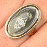 A late Georgian gold, blue and white enamel, split pearl and hairwork mourning ring.Ring size Q.