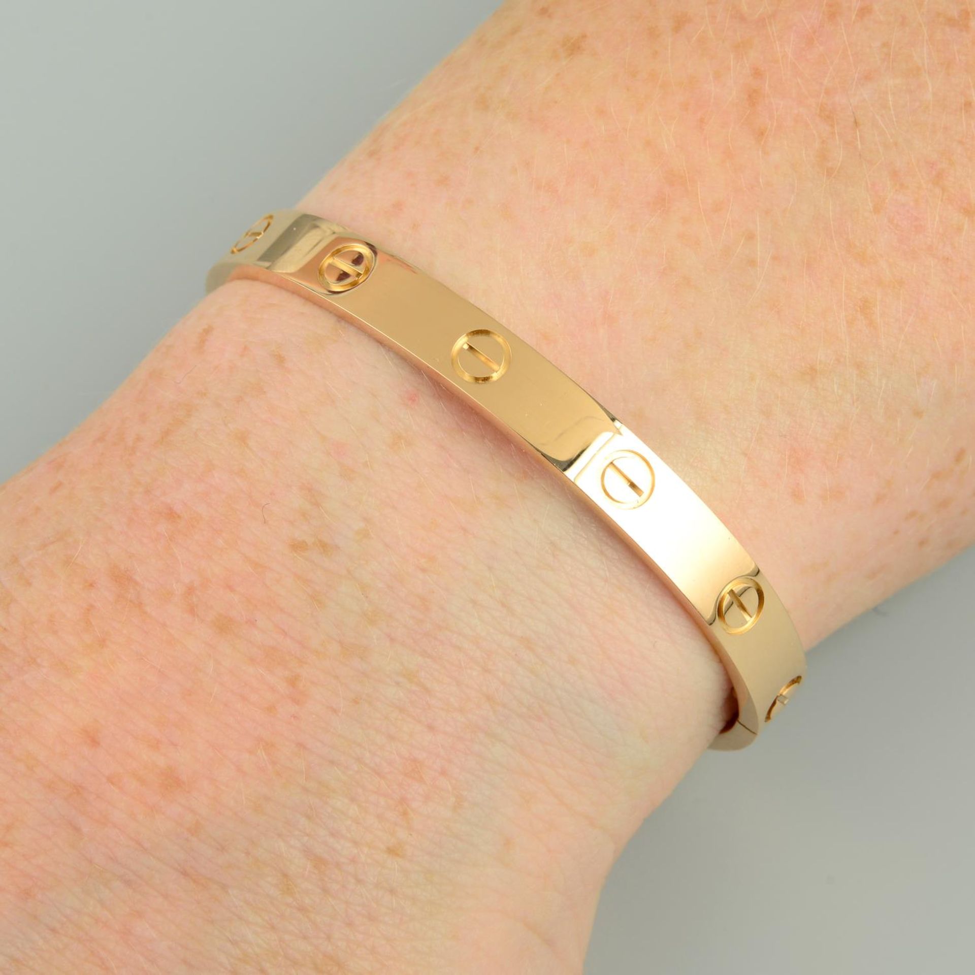 An 18ct gold 'Love' bangle, by Cartier.Swiss convention marks.