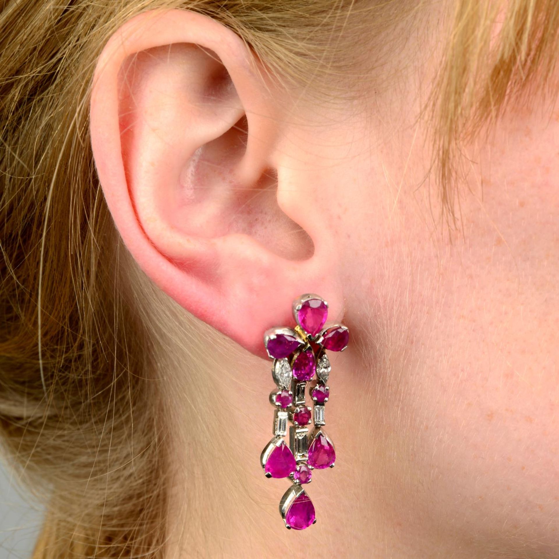 A pair of ruby and diamond earrings.Estimated total diamond weight 0.60ct,