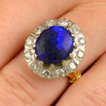 An 18ct gold black opal and brilliant-cut diamond cluster ring.Estimated dimensions of opal 12.1 by