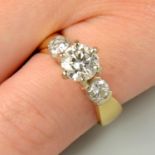 A brilliant-cut diamond single-stone ring, with diamond shoulders.