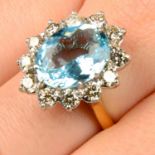 An 18ct gold aquamarine and brilliant-cut diamond cluster ring.Aquamarine weight 4.50cts.Total