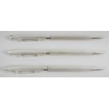 Three modern hallmarked silver cased propelling pencils,