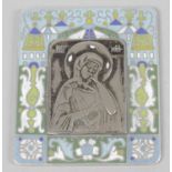 A small white metal religious picture or icon,