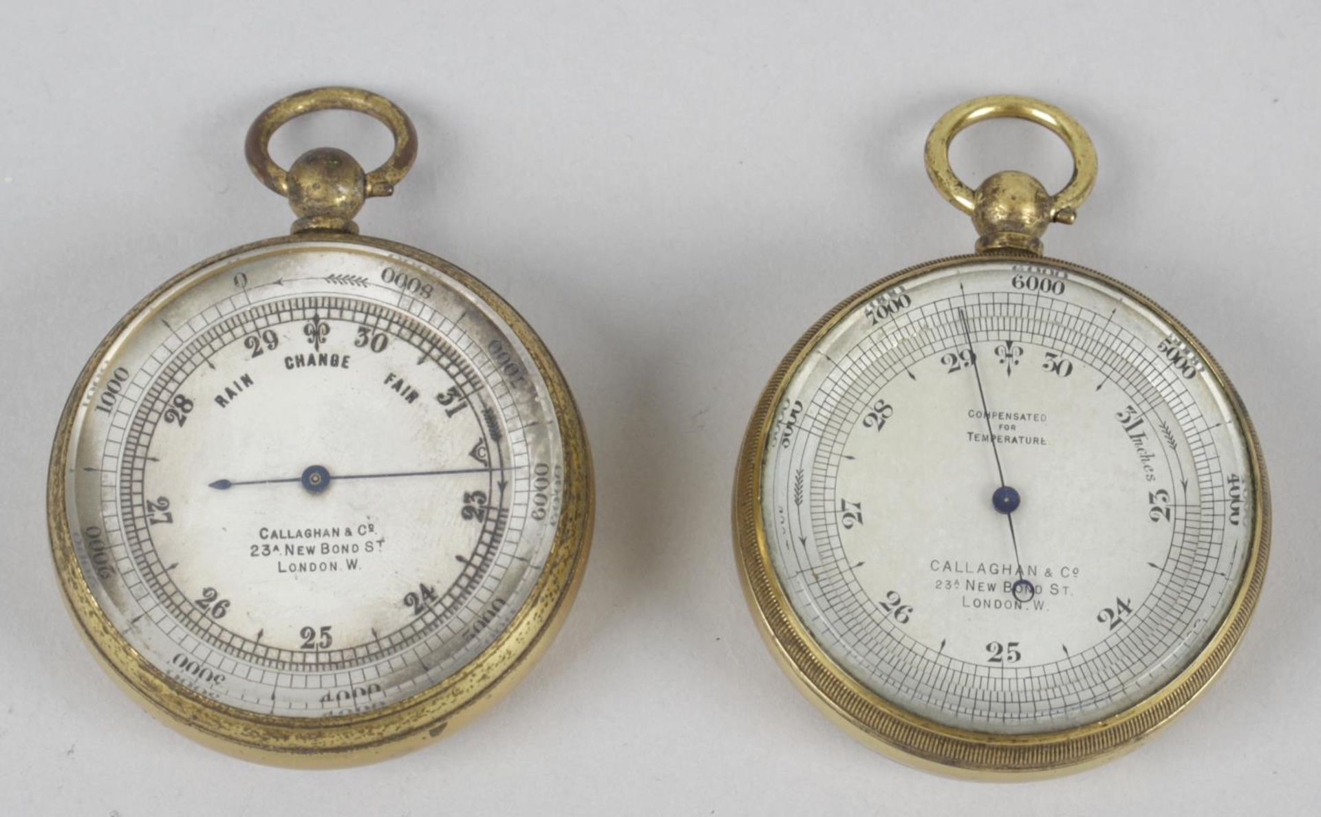 Two leather cased Callaghan & Co brass pocket barometers,