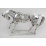 A modern silver filled figure modelled as a horse, raised upon a rectangular base.