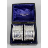 A pair of late Victorian silver napkin rings,