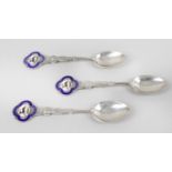 A collection of assorted souvenir and commemorative spoons,