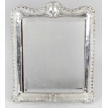 An Edwardian silver mounted mirror,