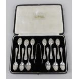 A cased set of twelve 1930's silver coffee spoons in Hanoverian style with shell motif to heel,