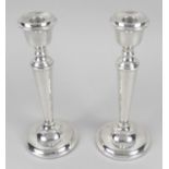 A pair of modern silver mounted candlesticks,