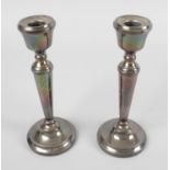 A pair of modern silver mounted candlesticks,