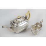 An early 19th century Irish silver teapot and matching cream jug,