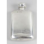 An Edwardian silver hip flask, the body of plain oblong form with hinged domed cover.