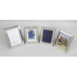 Four modern silver mounted photograph frames,