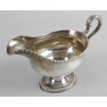 A late George II silver sauce boat,