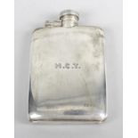A George V silver hip flask, of plain rounded rectangular form, with engraved initials and date.