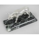 A novelty Spanish silver figure modelled as a bull, raised upon a stepped marble base.