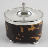 An Edwardian silver mounted and tortoiseshell veneer tea caddy of oval form,