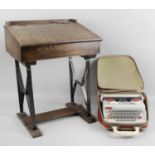 An early 20th century stained wooden child's desk on black painted metal supports,