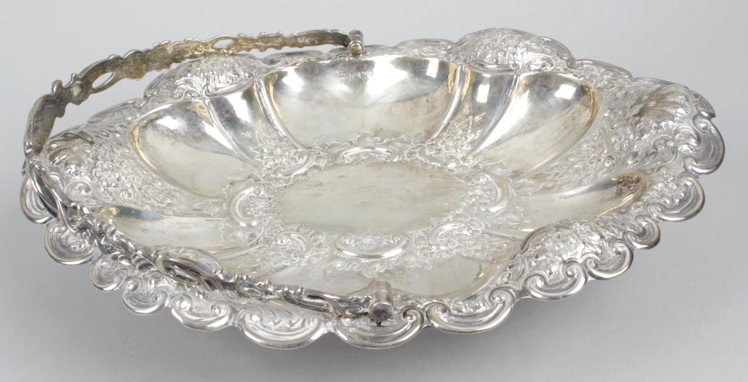 A late Victorian silver swing-handled pedestal basket,