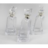 Three modern glass decanters each of square tapered,