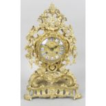 A 19th century French gilt bronze mantel clock of floral and scroll form,