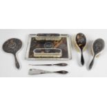 An early George V silver mounted and tortoiseshell part dressing table set,