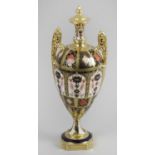 A Royal Crown Derby Old Imari 1128 pattern twin handle ovoid shaped pedestal vase and faux cover,