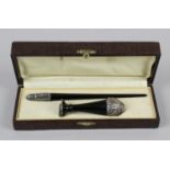 An Art Nouveau black resin dip pen with embossed metal nib holder,