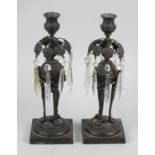 A pair of Regency bronze lustre candlesticks,