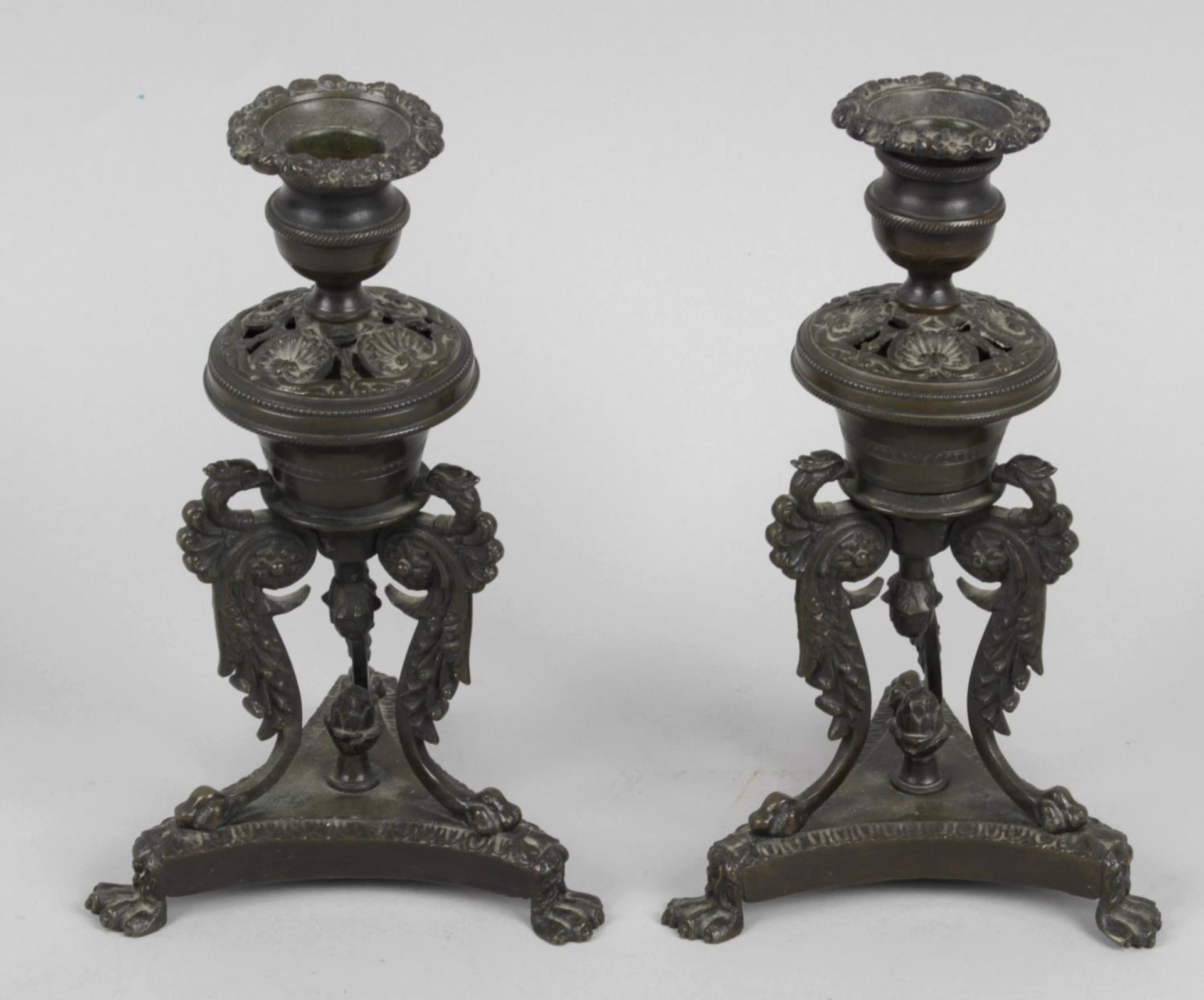 A pair of Regency bronze candlesticks,