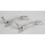 A pair of modern silver knife rests, each modelled as a stylised hare with elongated body.