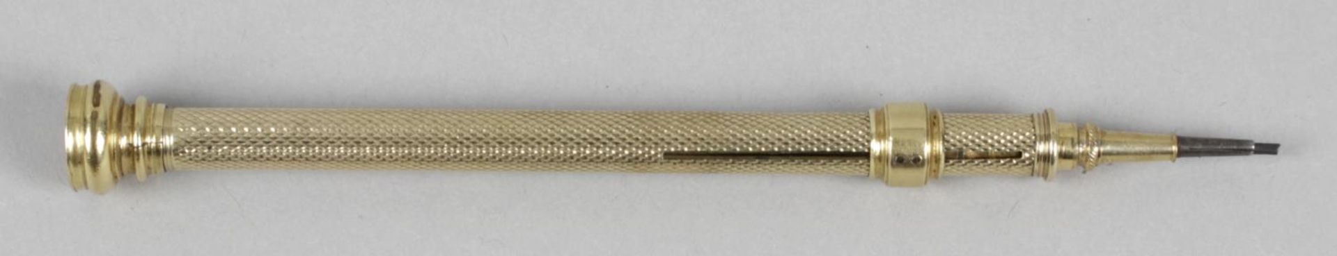 A unmarked gold push action pencil,