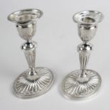 A pair of modern silver candlesticks,