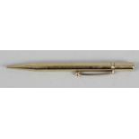 A 9ct gold propelling pencil, of plain cylindrical form, marked JM&Co 9 375, 4.25 (11cm) long.