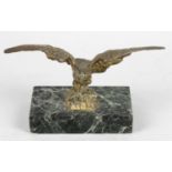 A cast bronze desk weight modelled as an eagle with outstretched wings,