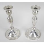 A pair of silver mounted candlesticks,