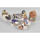 A group of eight Royal Crown Derby porcelain paperweights,