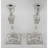 A pair of early George V silver mounted candlesticks in Neo-Classical style,