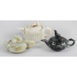 Three 20th century oriental carved hardstone teapots and covers,