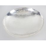 A cased modern silver dish, of circular footed form, with planished finish to the whole.
