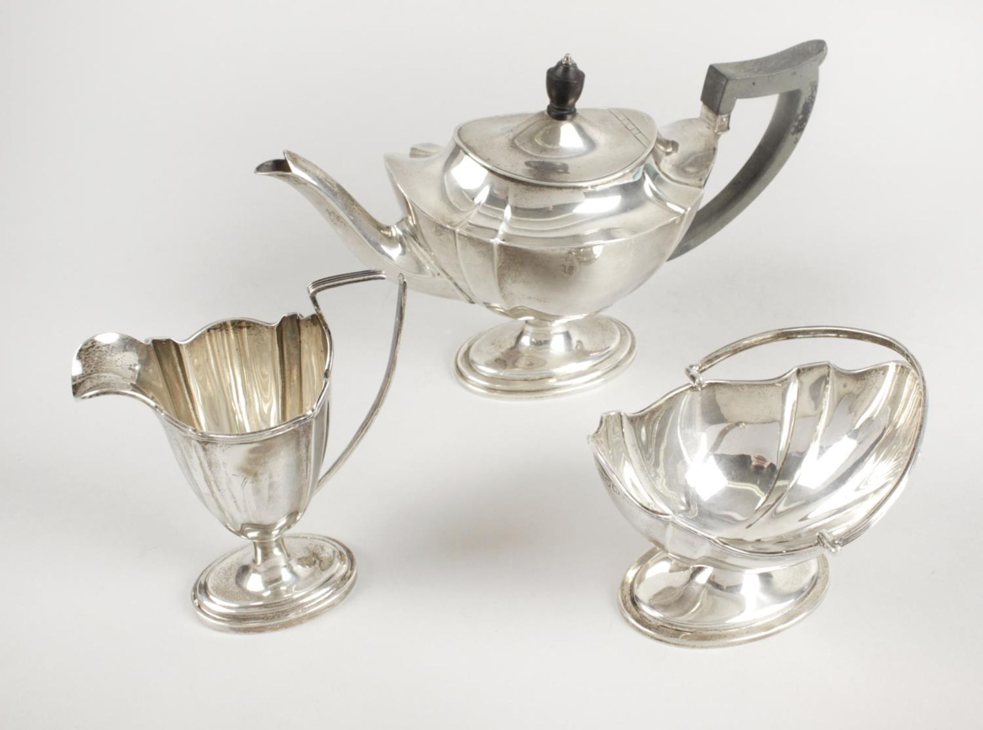 A late Victorian silver matched bachelor three piece tea service,